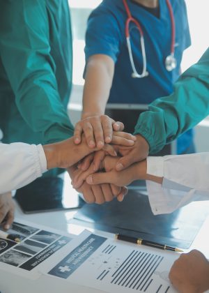 Doctors and nurses in a medical team stacking hands